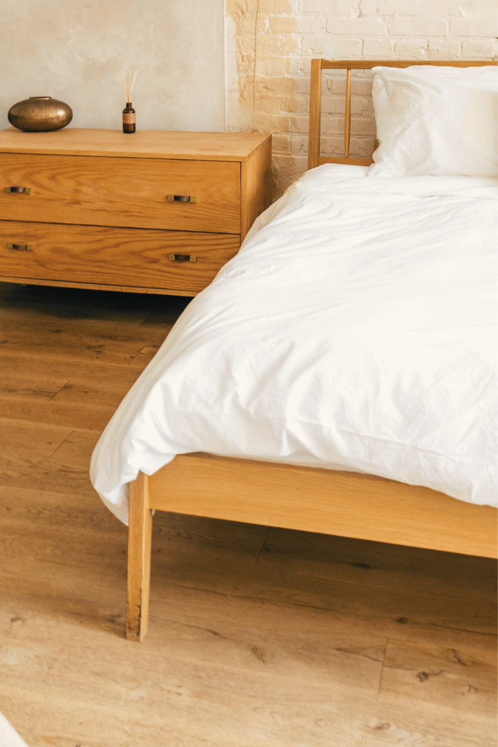 Oak fluted bedside cabinet with warm wood texture and a Japandi-inspired calm aesthetic.