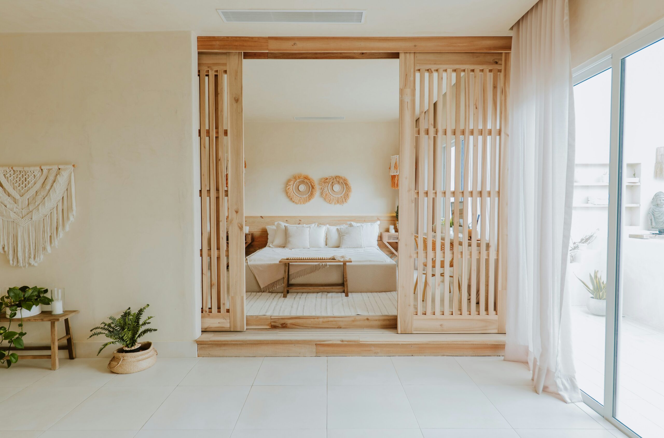 Minimal bedroom with clear surfaces, clean nightstand, and uncluttered styling that creates visual calm and space.