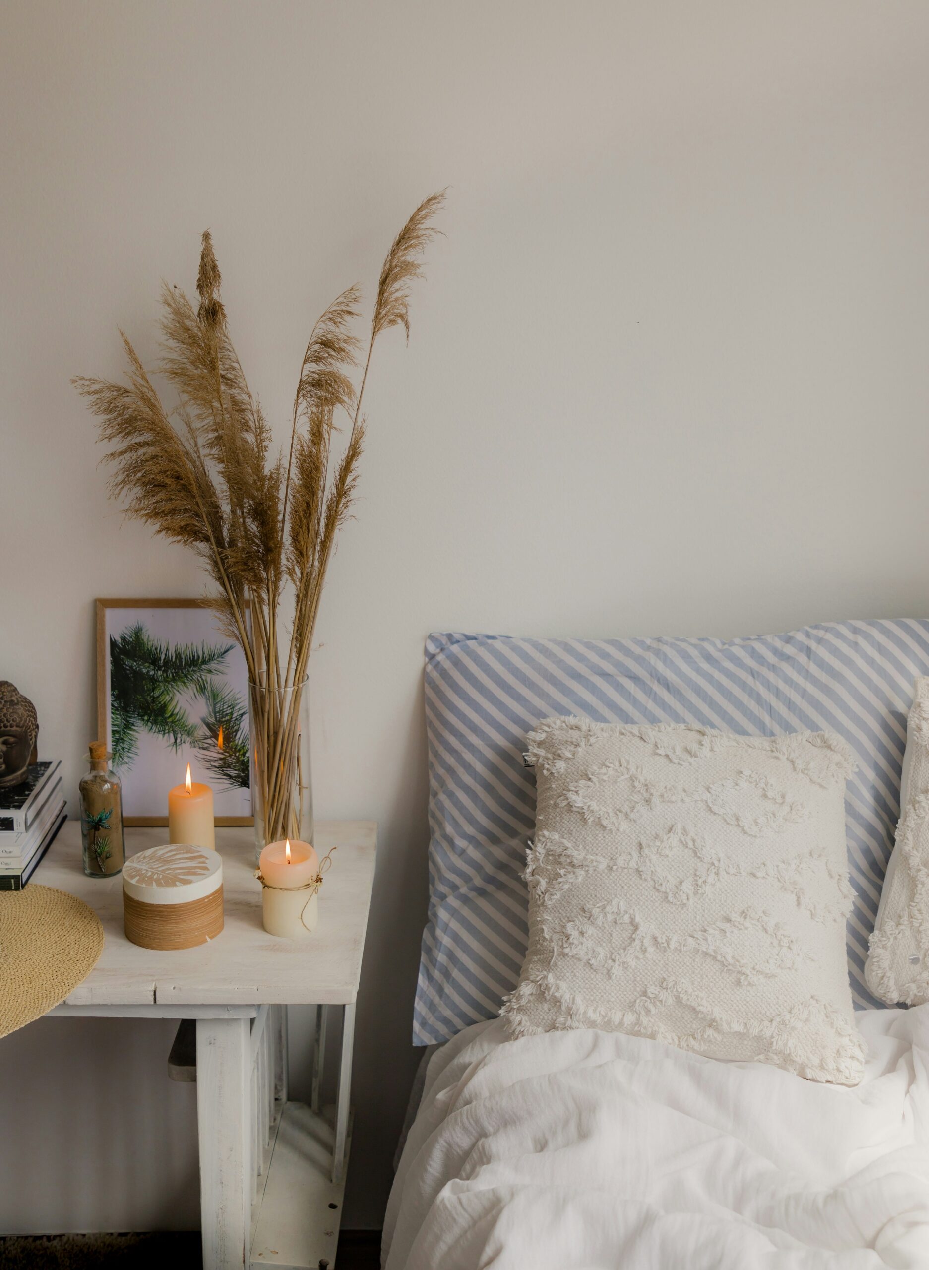 Bedroom styled with one organic accent using dried stems and natural textures for a softer feel.