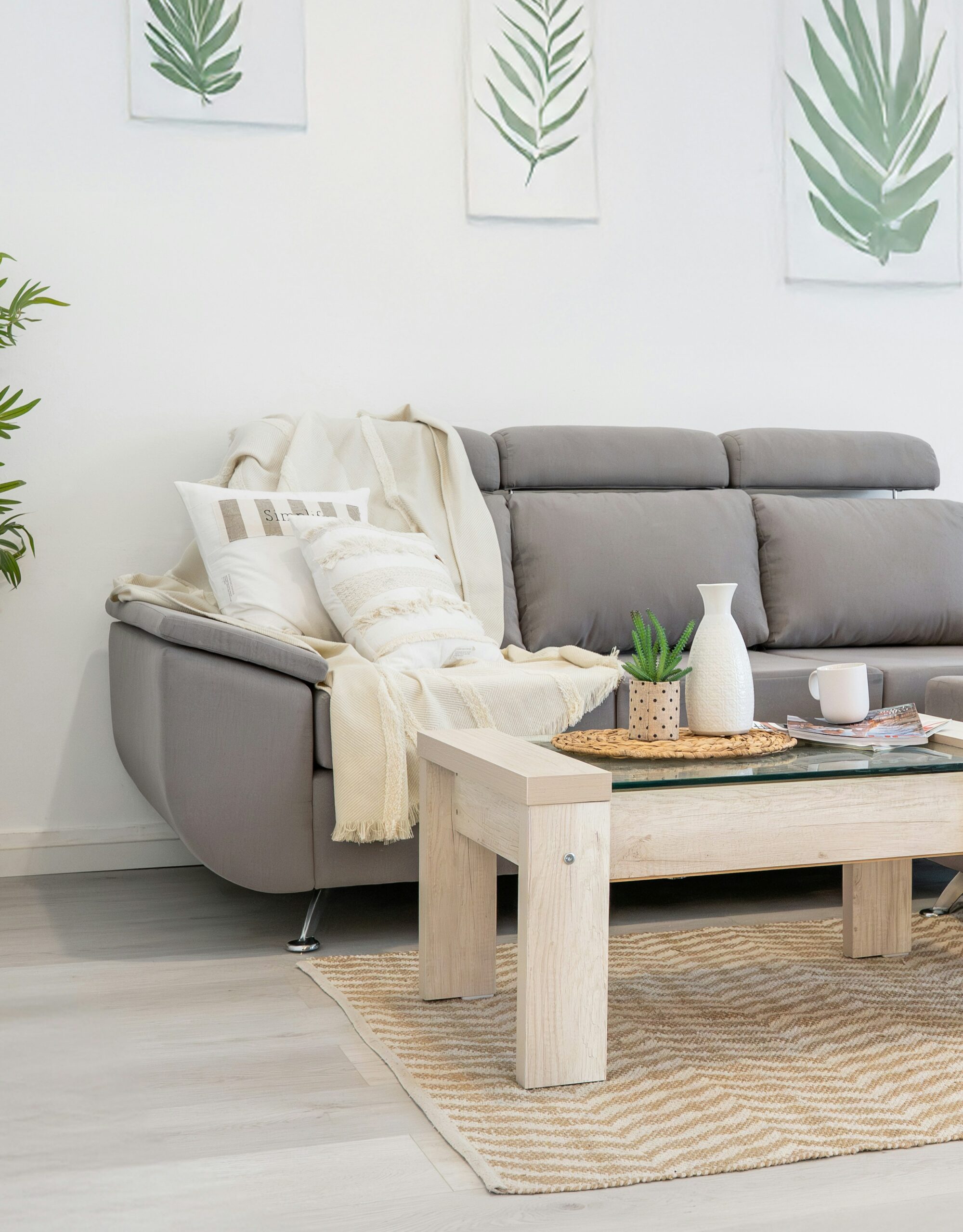 Low neutral Japandi sofa styled with soft cushions and a simple throw in a calm minimalist living room.