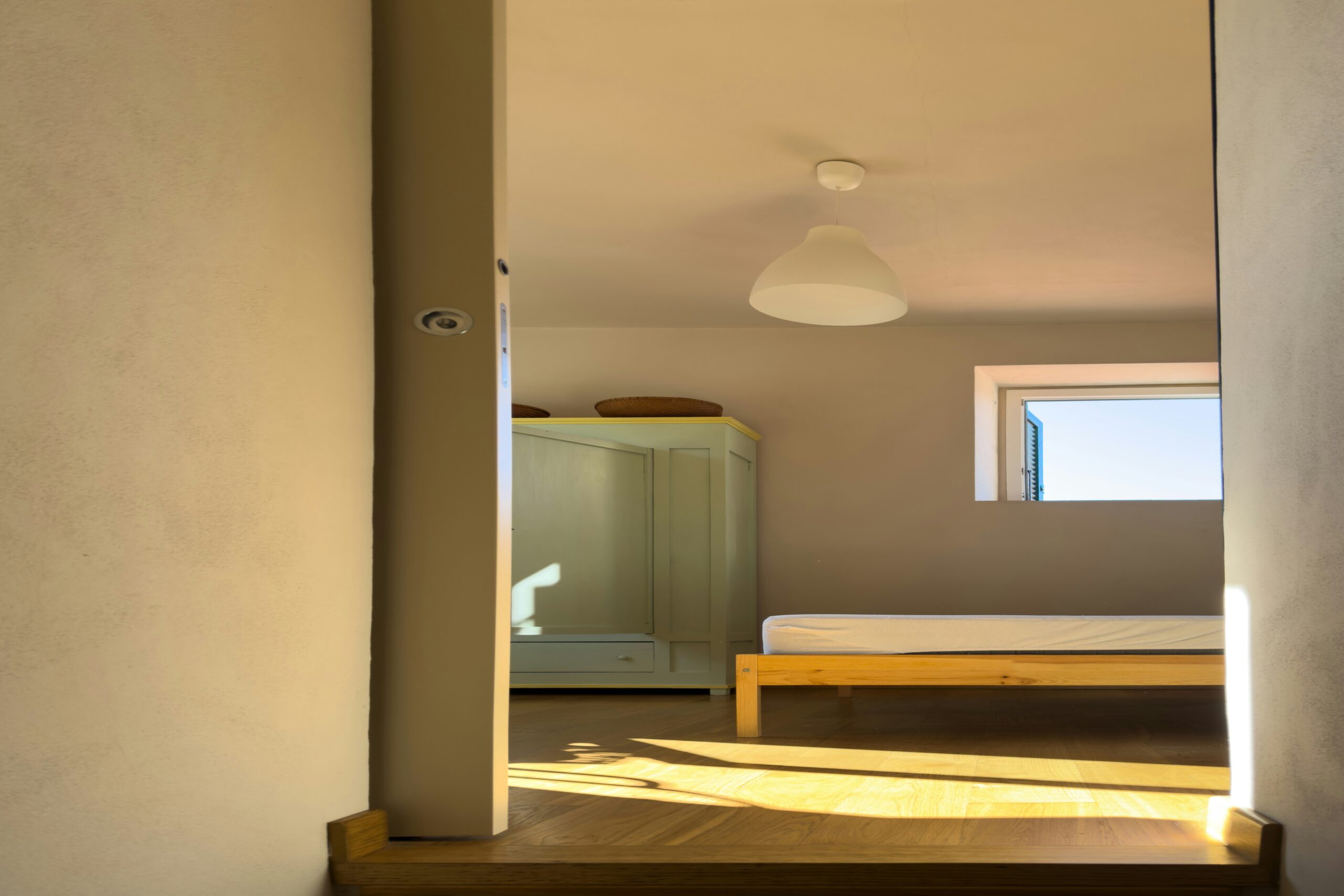 Minimal bedroom with compact furniture and smart storage that keeps the space feeling open and functional.