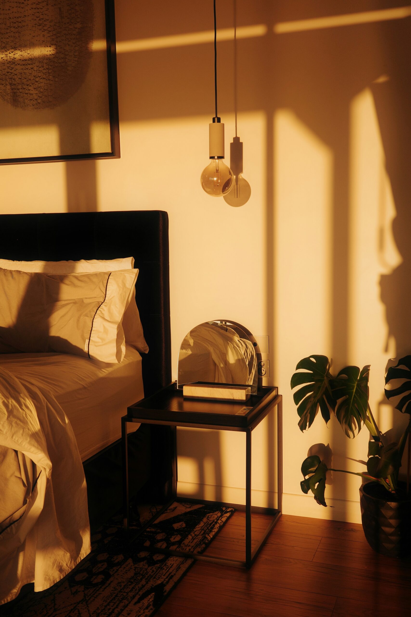 Cozy bedroom with layered bedding and warm ambient light creating a soft intentional atmosphere.