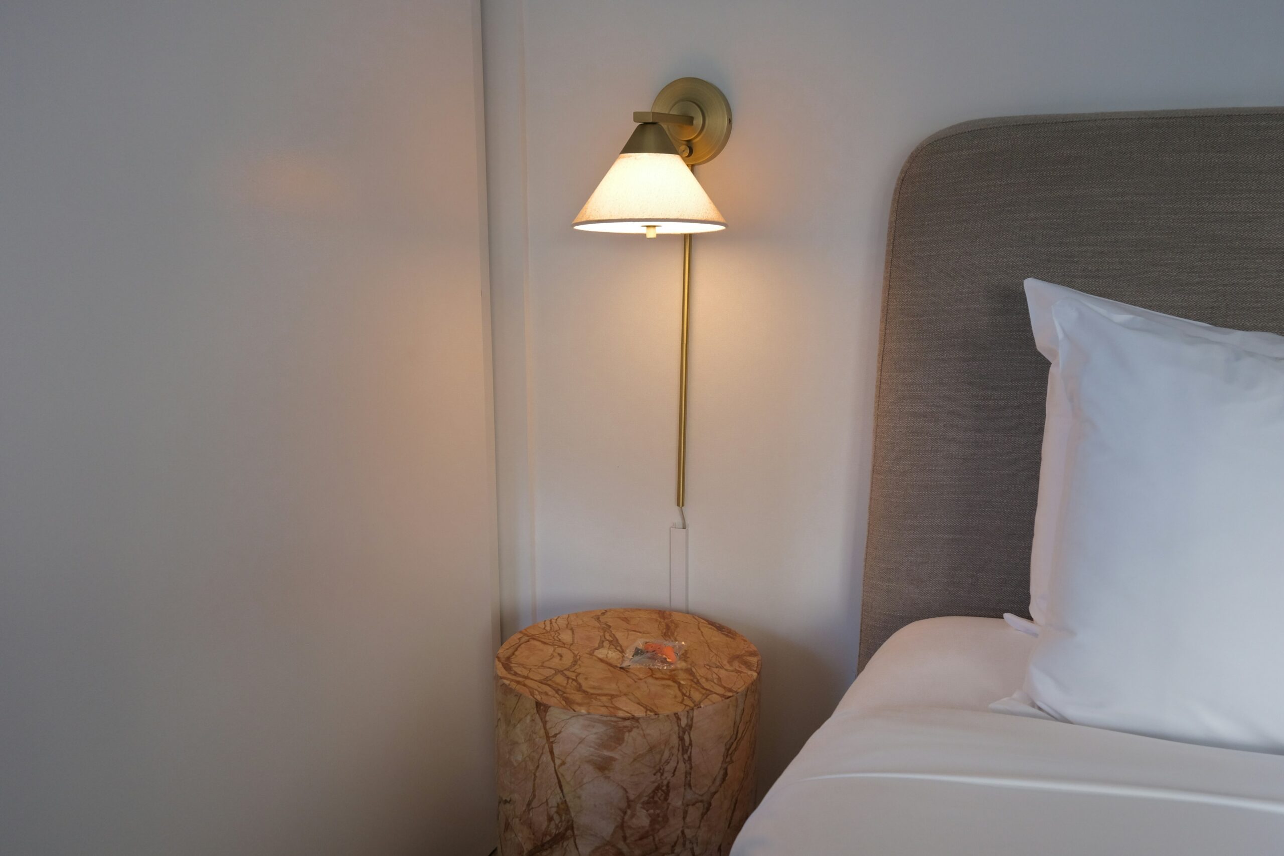 Bedroom with layered lighting from multiple warm sources creating a restful and balanced nighttime atmosphere.